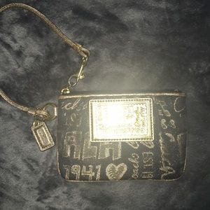 Black and gold coach wristlet